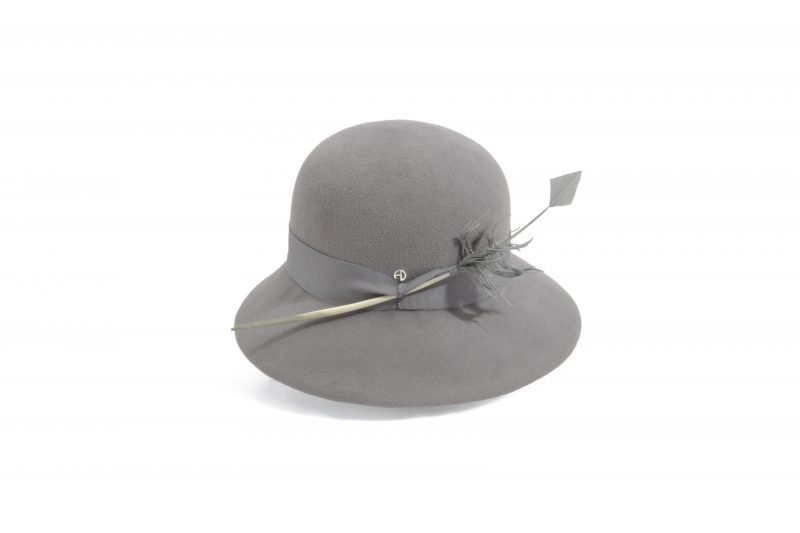 Cloche hat adorned with a feather